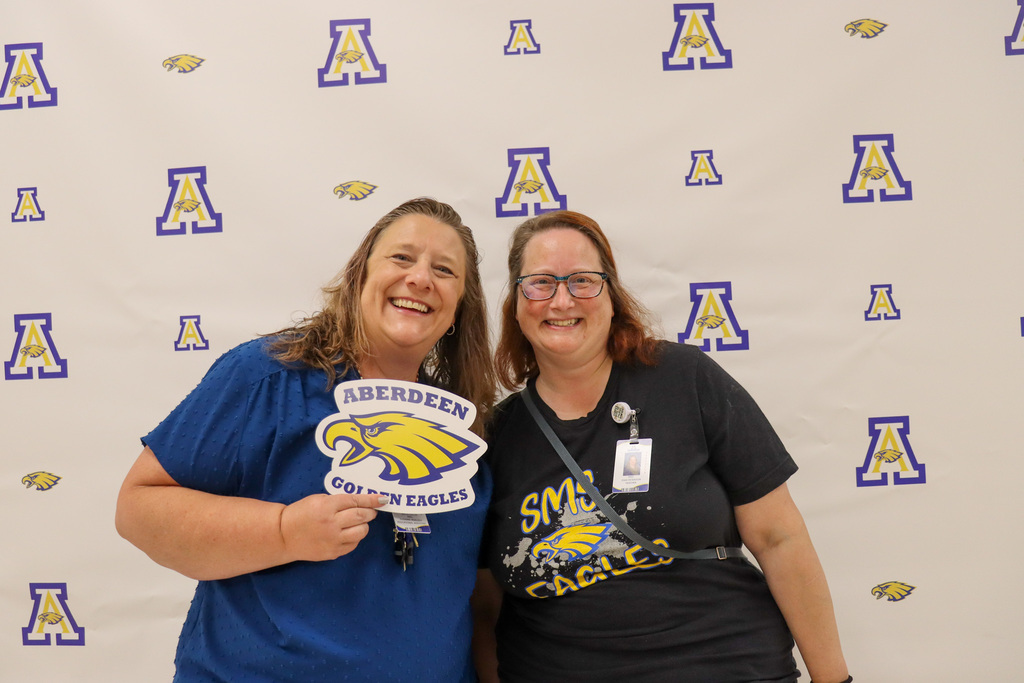 Aberdeen Public Schools teachers smiling and holding an Eagles sign