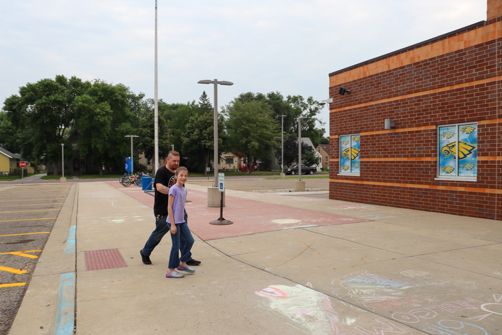 A sixth grader walking into Simmons with a family member