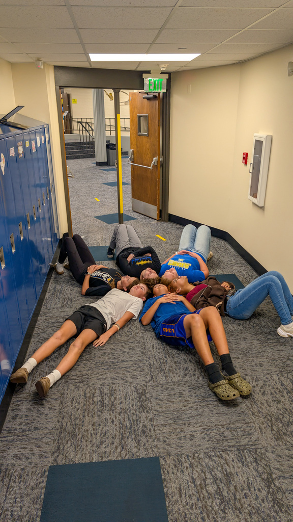 Holgate students lying in a circle during a scavenger hunt