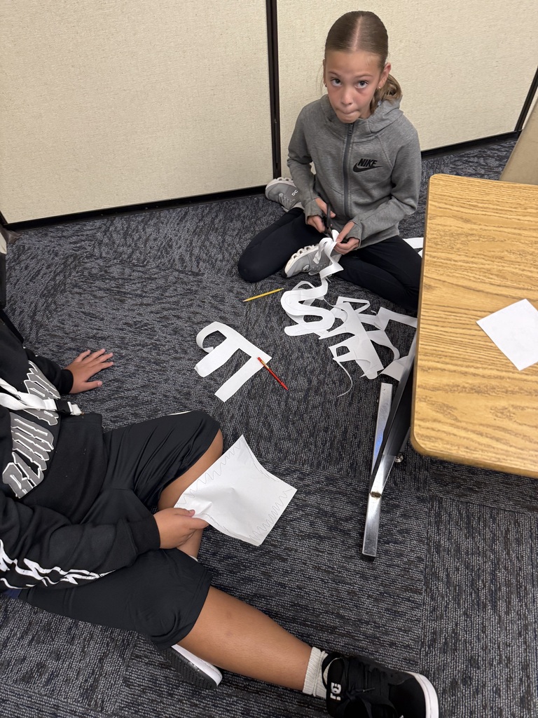 Student's cutting paper.