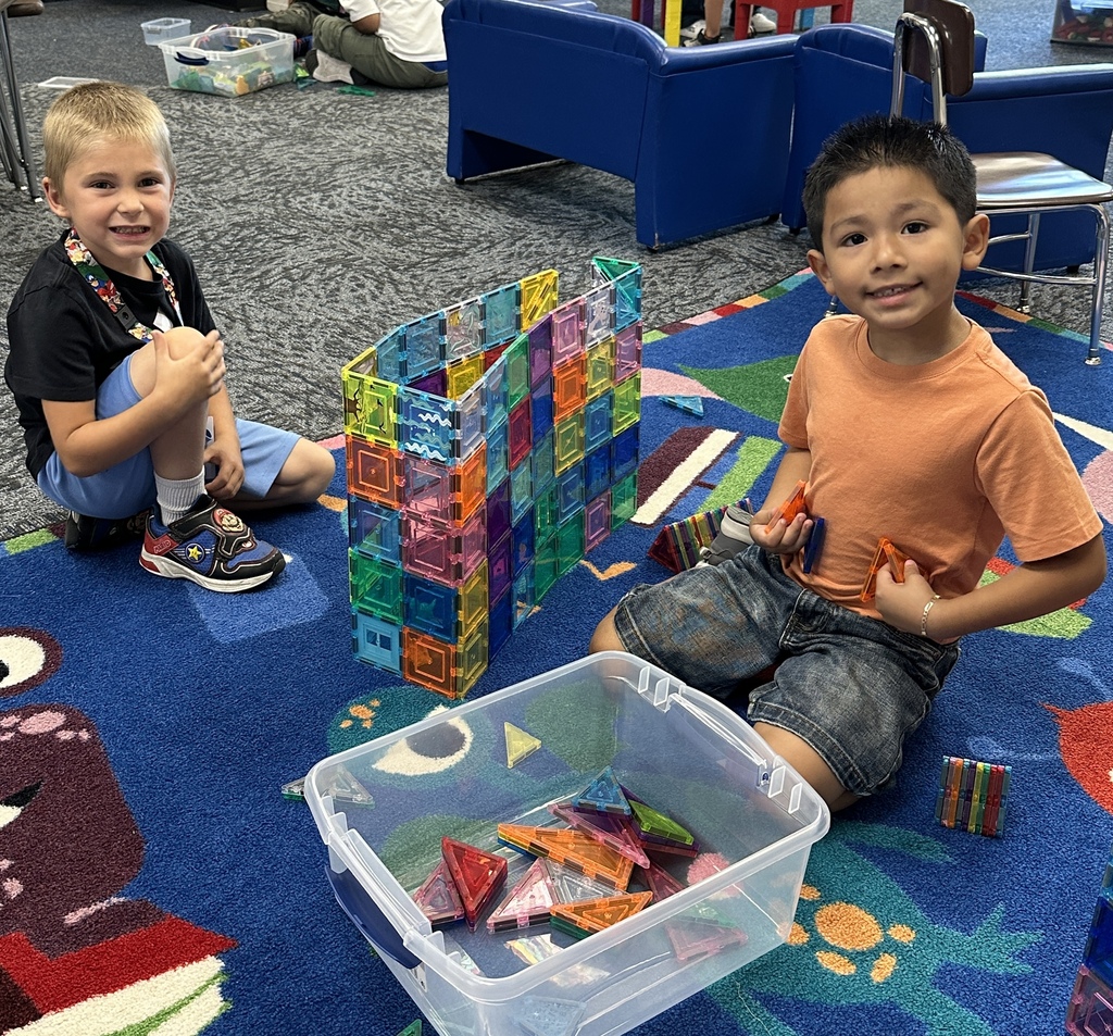 kindergarten students building a tower with magna tiles