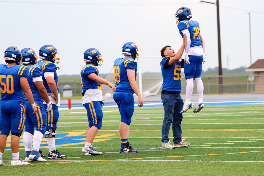 CHS football player lifting up another player before the game