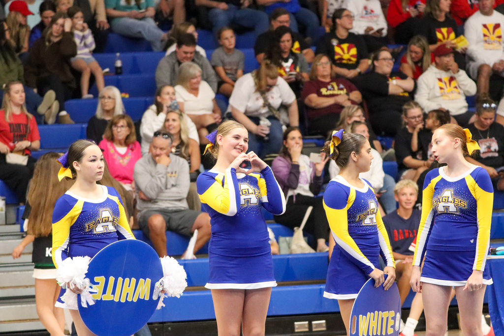 CHS cheerleader making a heart symbol to a loved one before their performance