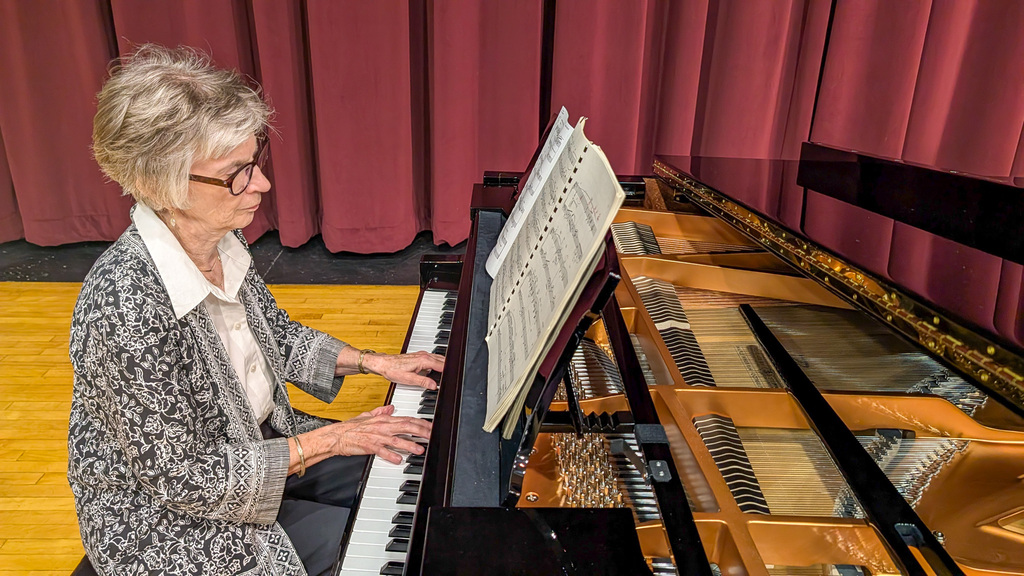 Sue Gates playing Central's brand new piano