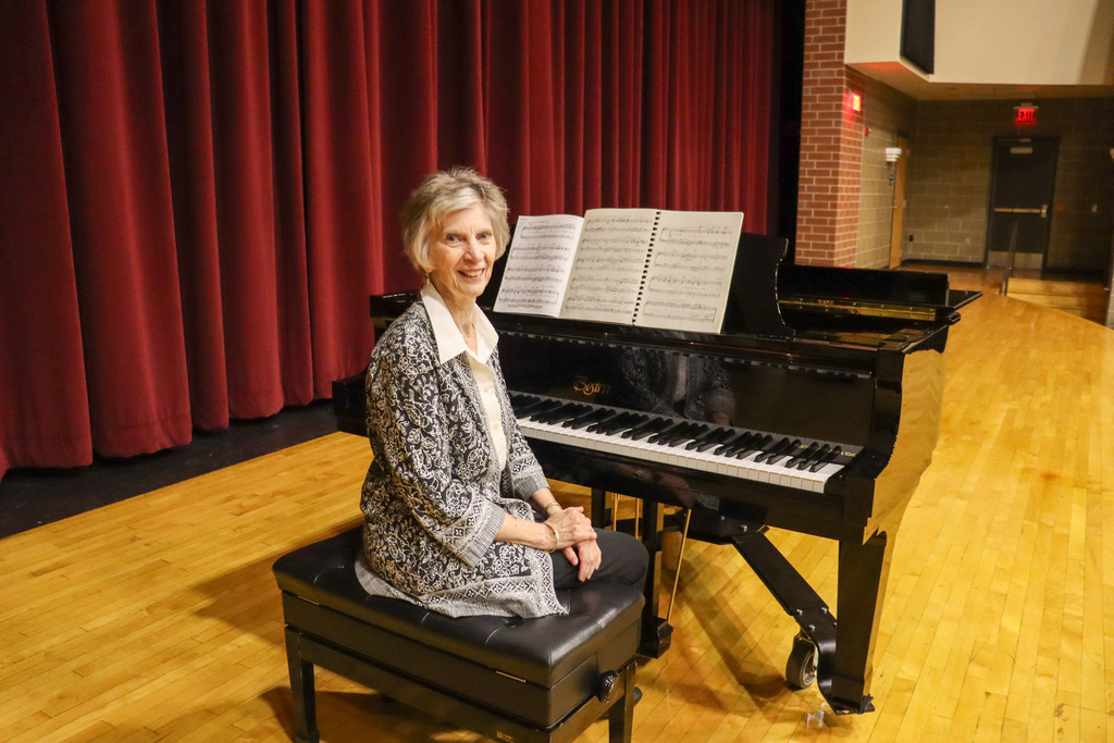 Sue Gates sitting at Central's brand new piano