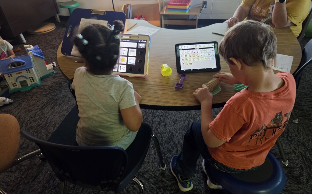 Two students using communication devices.