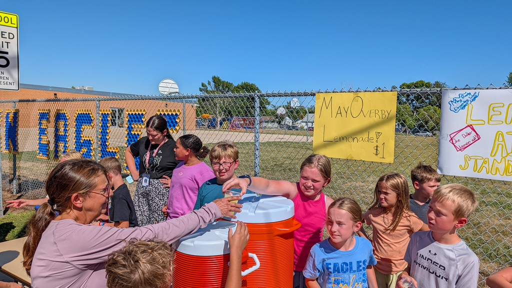 May Overby students and staff running a lemonade stand outside the school