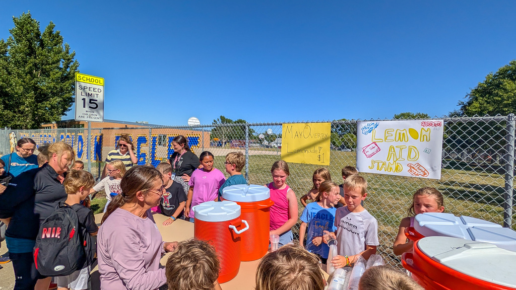May Overby students and staff running a lemonade stand outside the school