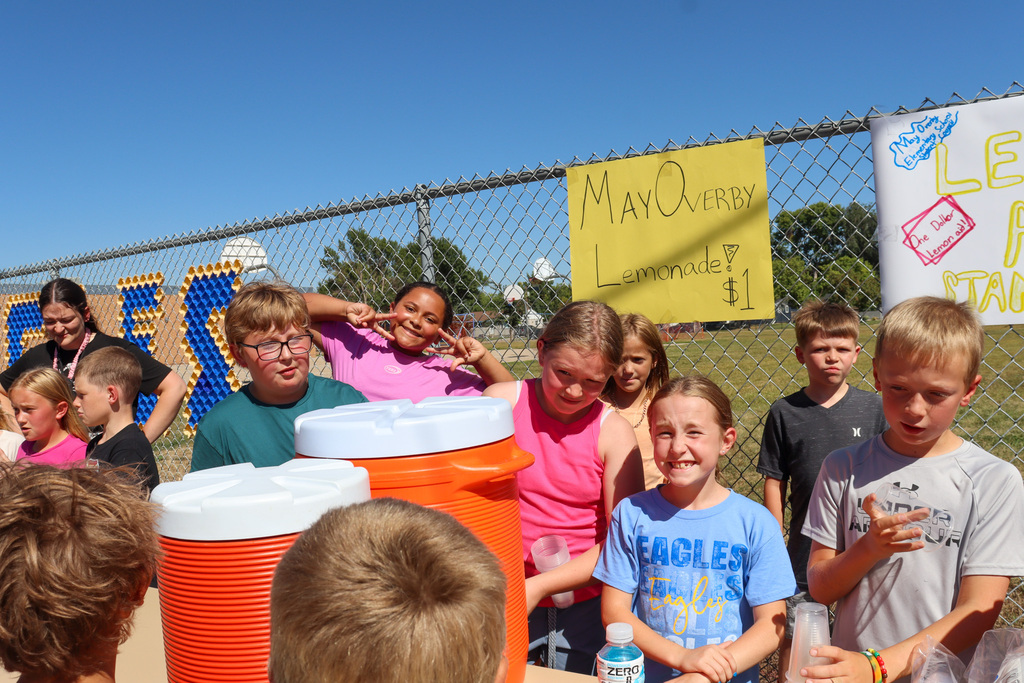 May Overby students and staff running a lemonade stand outside the school