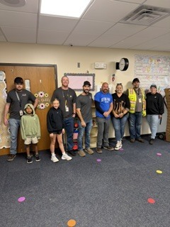 A group of 3M employees delivery snack packs to our students at Mike Miller.