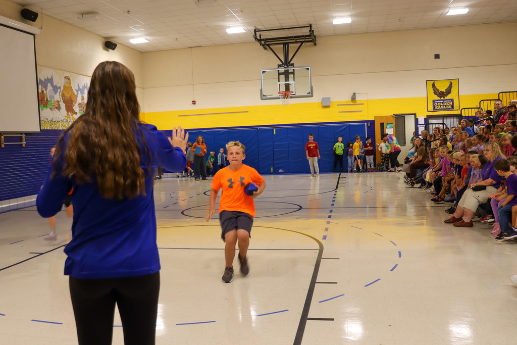 May Overby student participating in a relay at the Homecoming Assembly