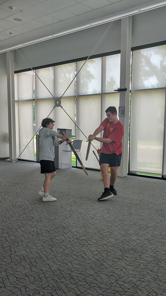 CHS actors demonstrating stage combat at the library