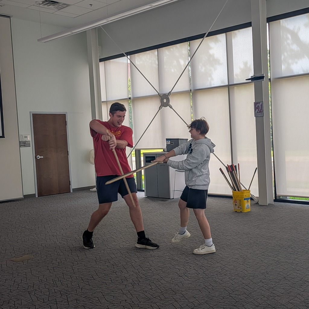 CHS actors demonstrating stage combat at the library