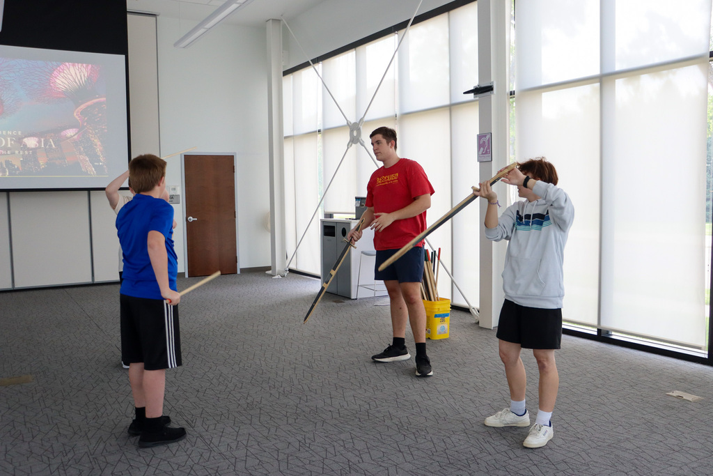 CHS actors demonstrating stage combat at the library