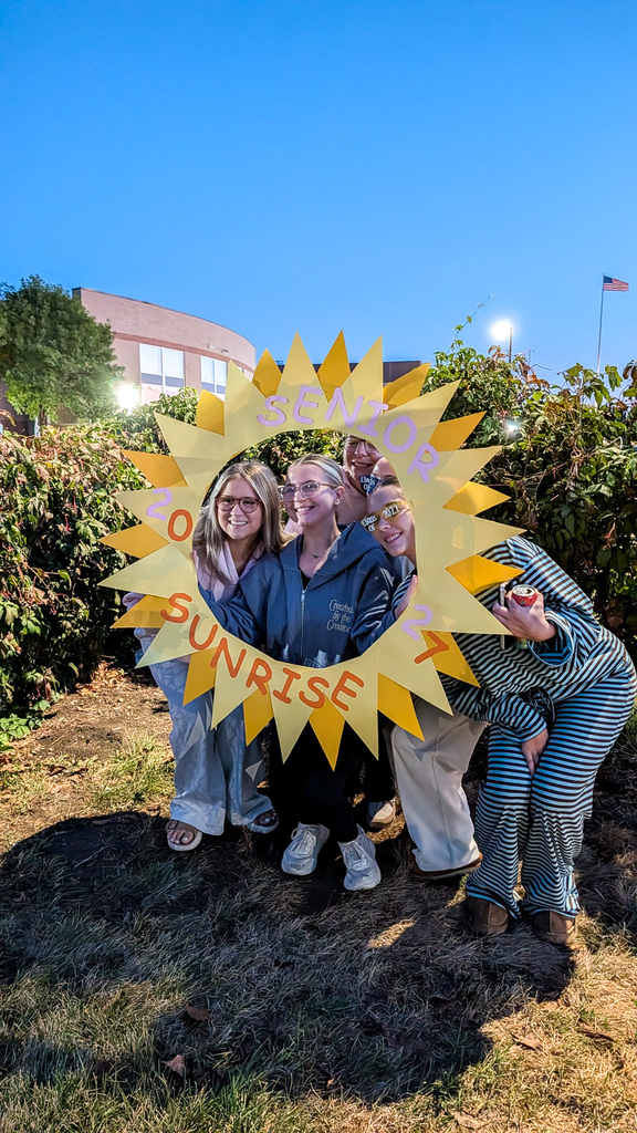 CHS seniors posing with a Senior Sunrise frame wearing class of 2027 sunglasses