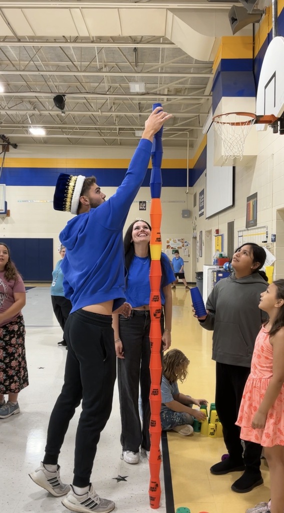 Homecoming King and Queen stacking cups with 5th graders at Lincoln