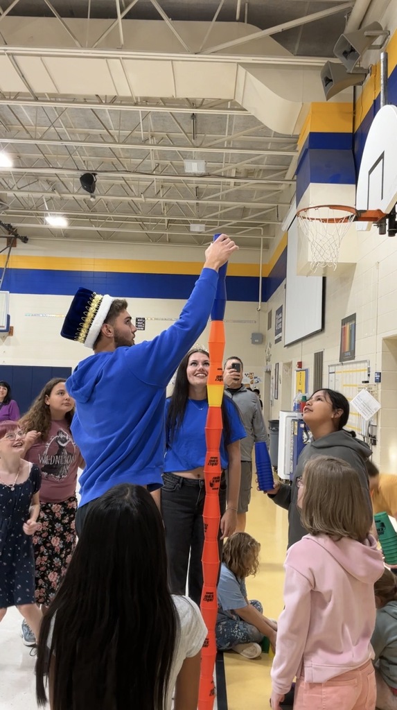 Homecoming King and Queen stacking cups with 5th graders at Lincoln