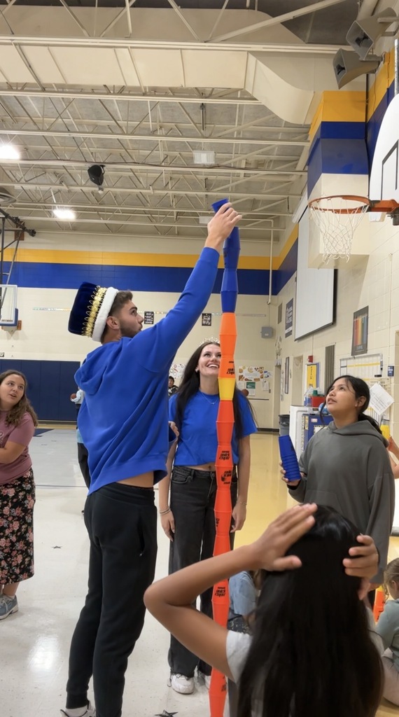 Homecoming King and Queen stacking cups with 5th graders at Lincoln