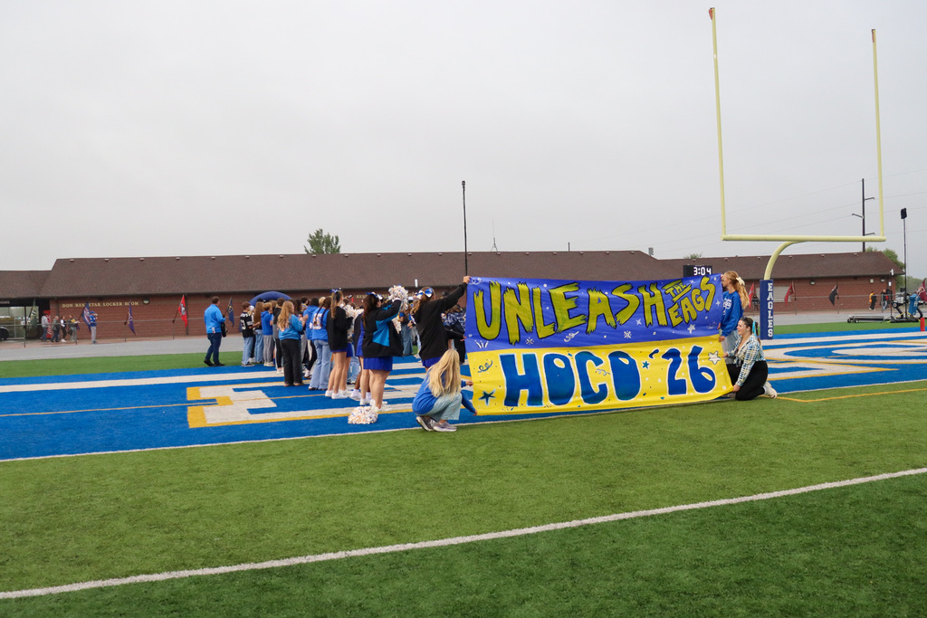 CHS students holding a homecoming banner that says Unleash the Eagls, Hoco 26