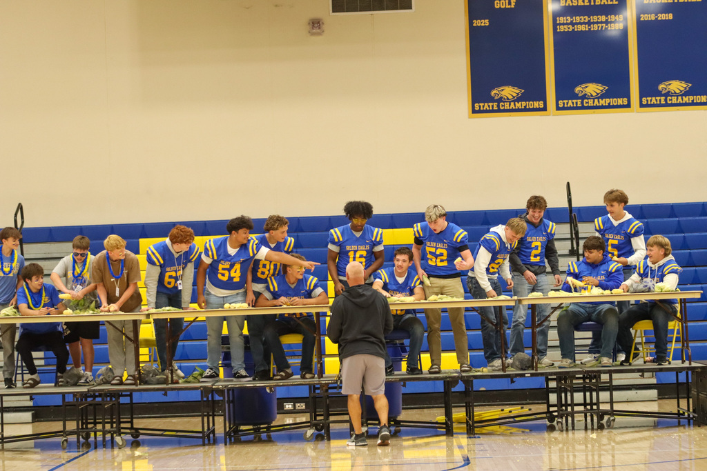 football players participating in a corn skit at the pep rally