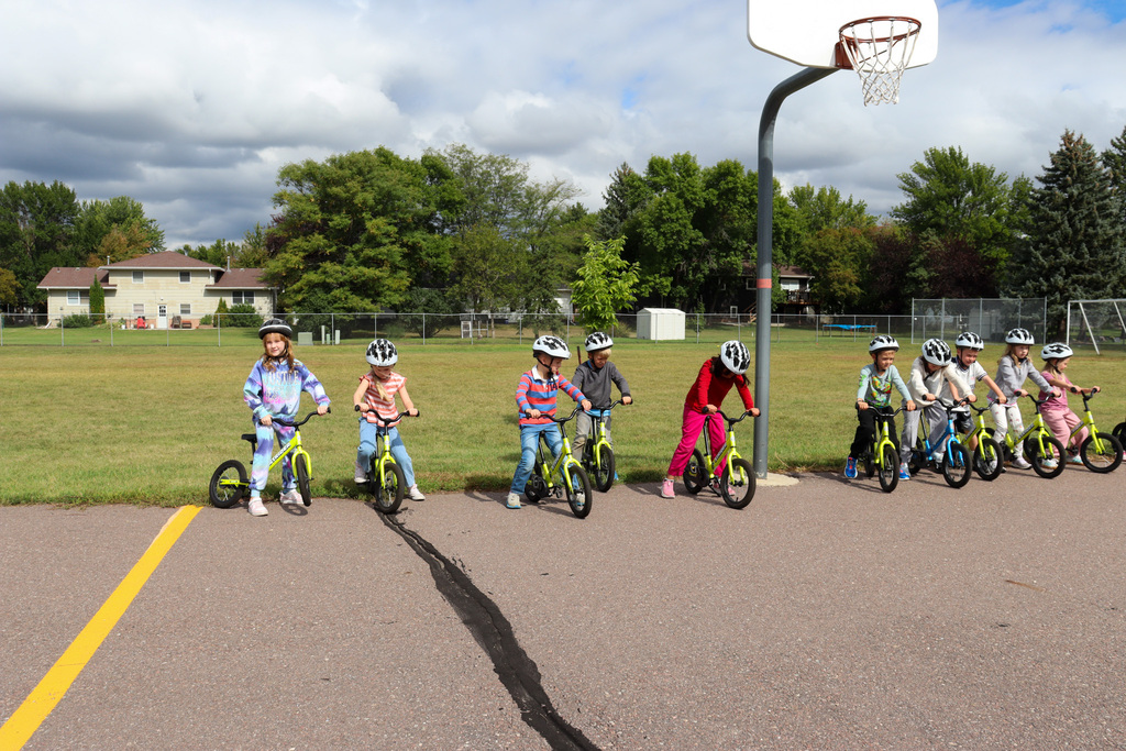 C.C. Lee students riding Strider bikes during gym class