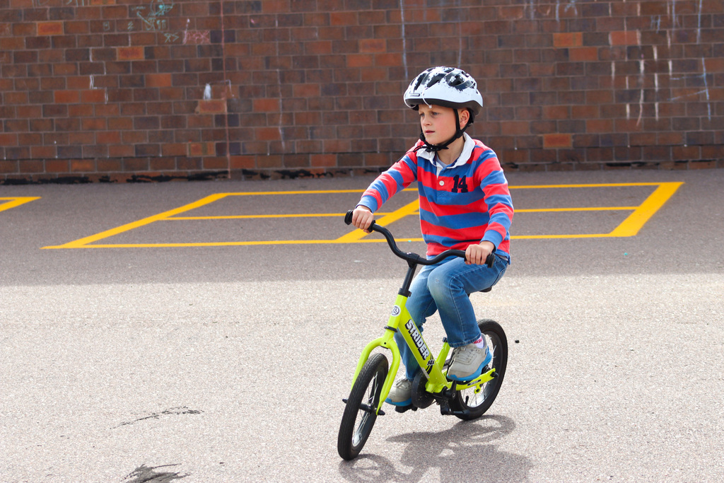 A C.C. Lee student riding a Strider bike during gym class 