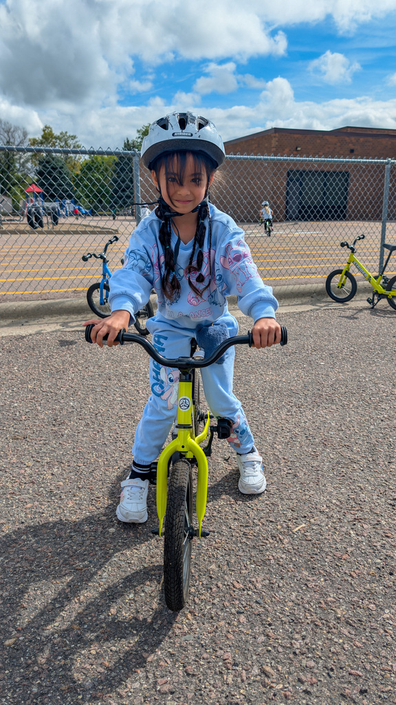 A C.C. Lee student riding a Strider bike during gym class
