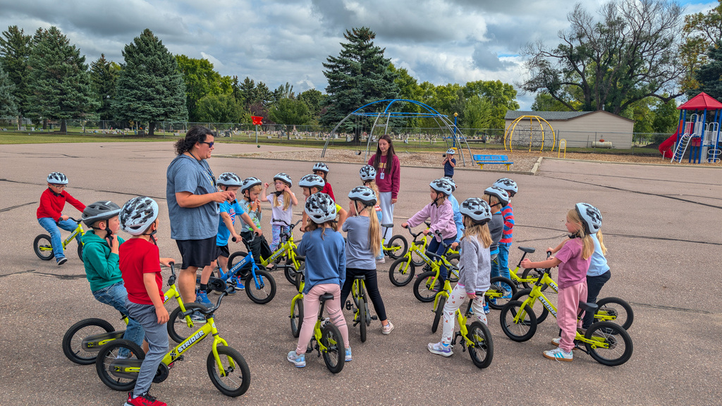 C.C. Lee students riding Strider bikes during gym class