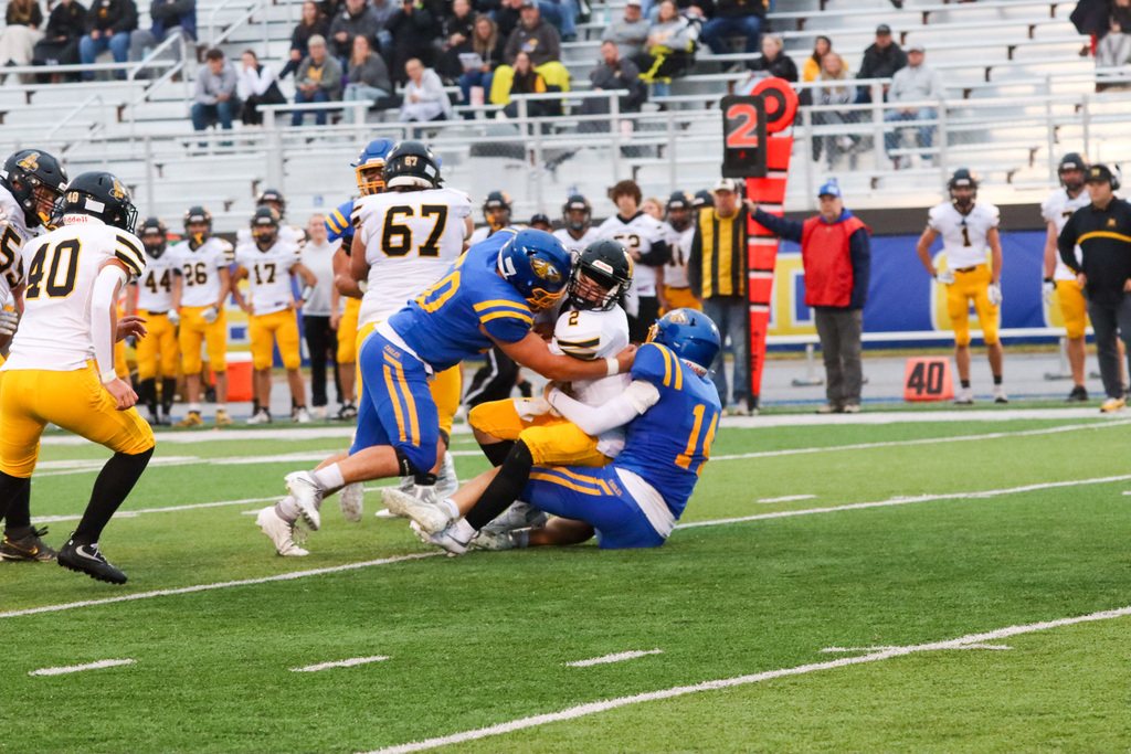 CHS football players sacking the Mitchell quarterback