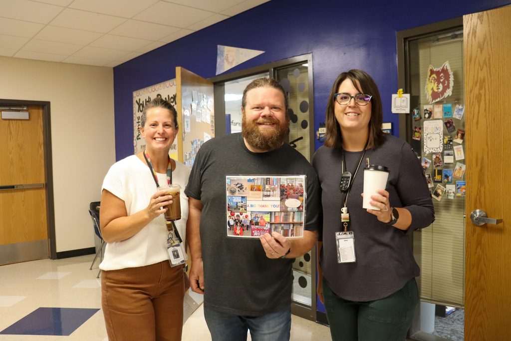 SMS staff members with their coffees and Brody from the Market