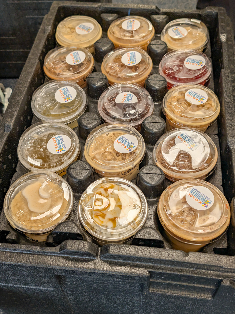 A pallet of coffees from the Market with stickers from the library