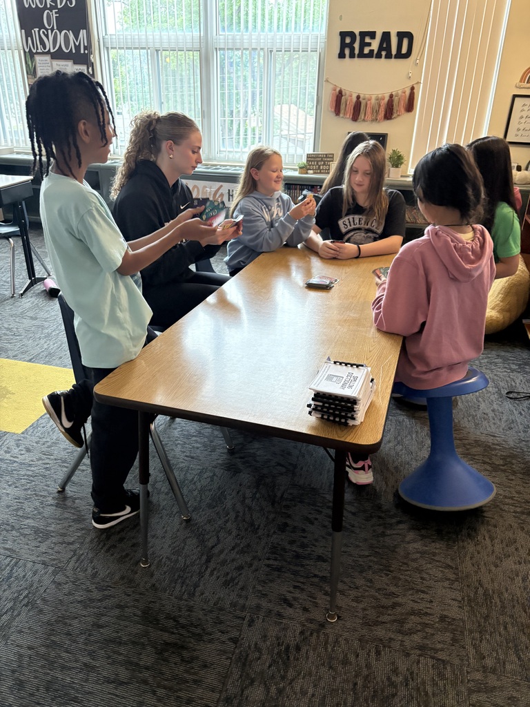 Students playing games with NSU volleyball player
