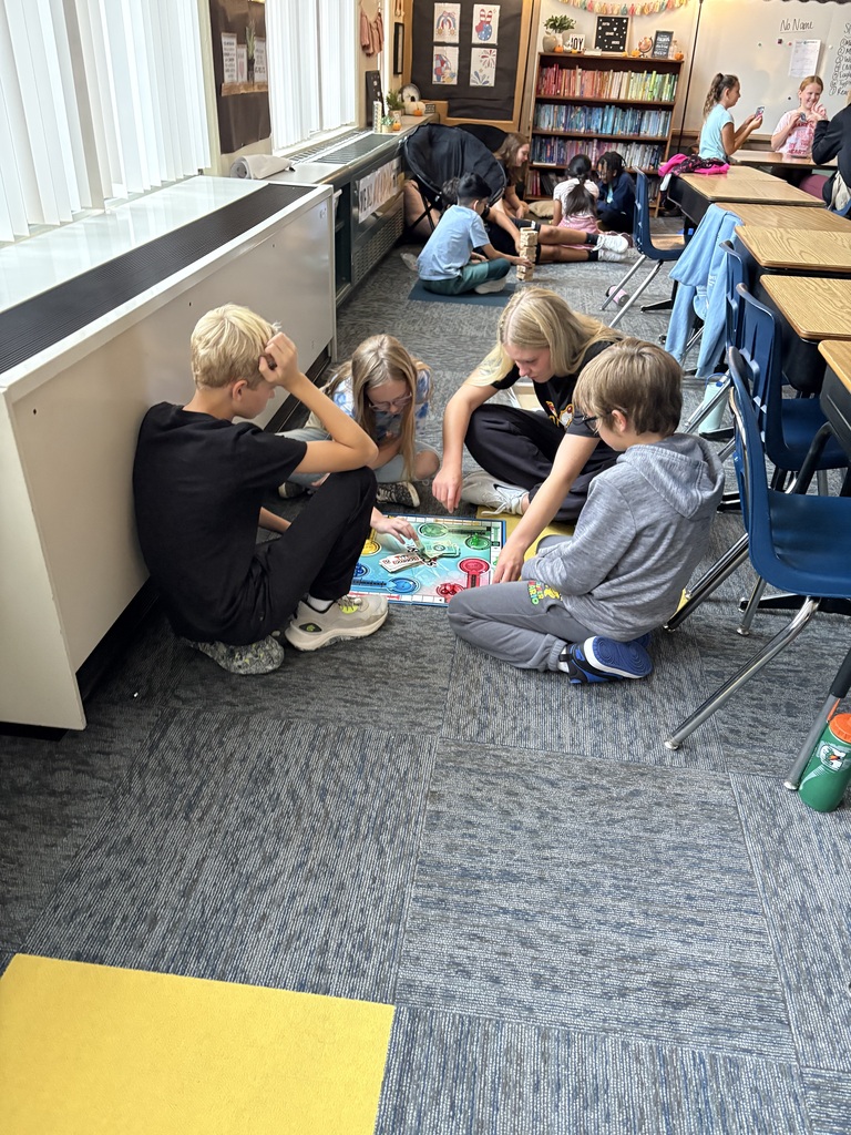 Students playing games with NSU volleyball player