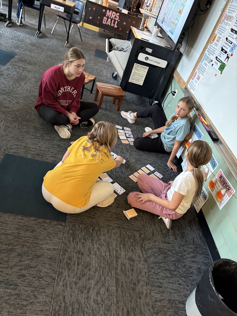 Students playing games with NSU volleyball player