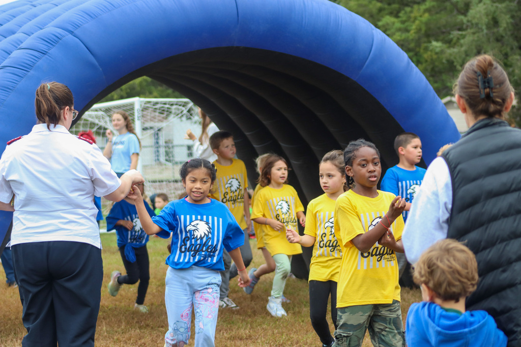 Simmons Elementary students participating in a fun run outside the school
