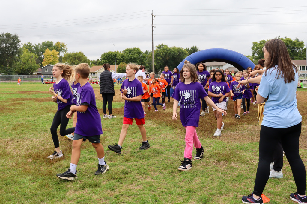 Simmons Elementary students participating in a fun run outside the school