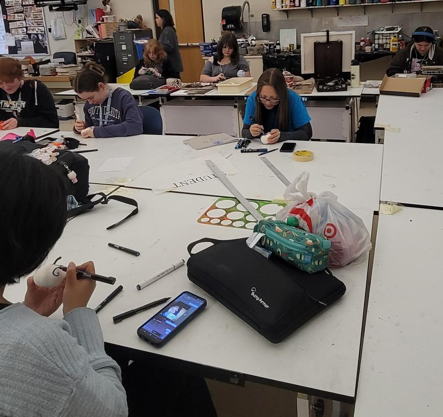 Art club members are working on decorating pumpkins!