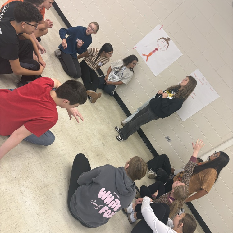 Golden Crew students sitting on the floor