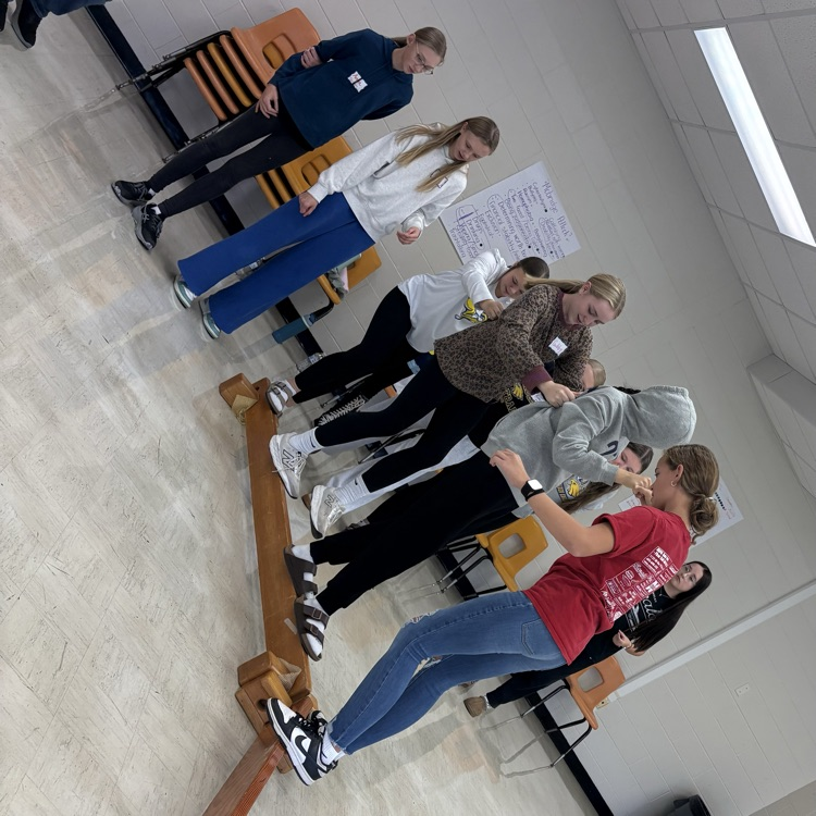 Golden Crew students on a balance beam