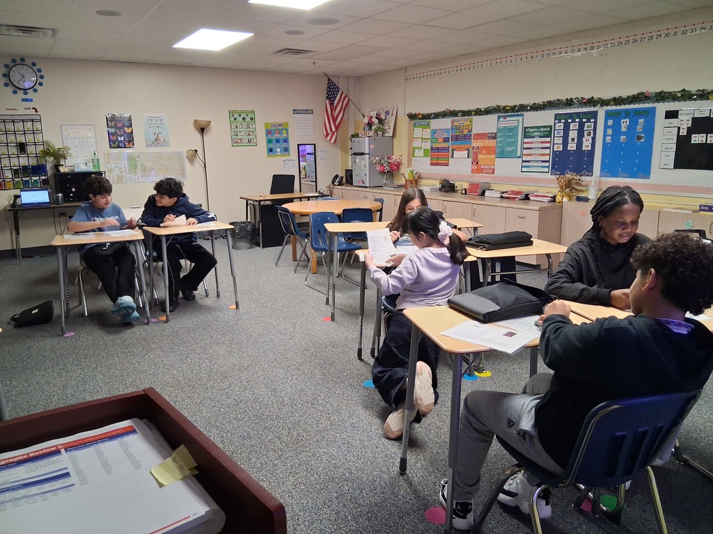 7th grade students working with a partner to practice ordering from a menu and taking an order.