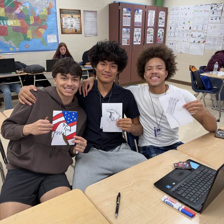 Student working on cards at their desks.