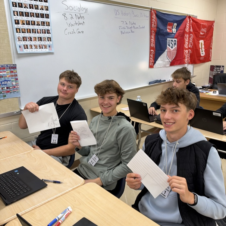 Students working on cards at their desks.