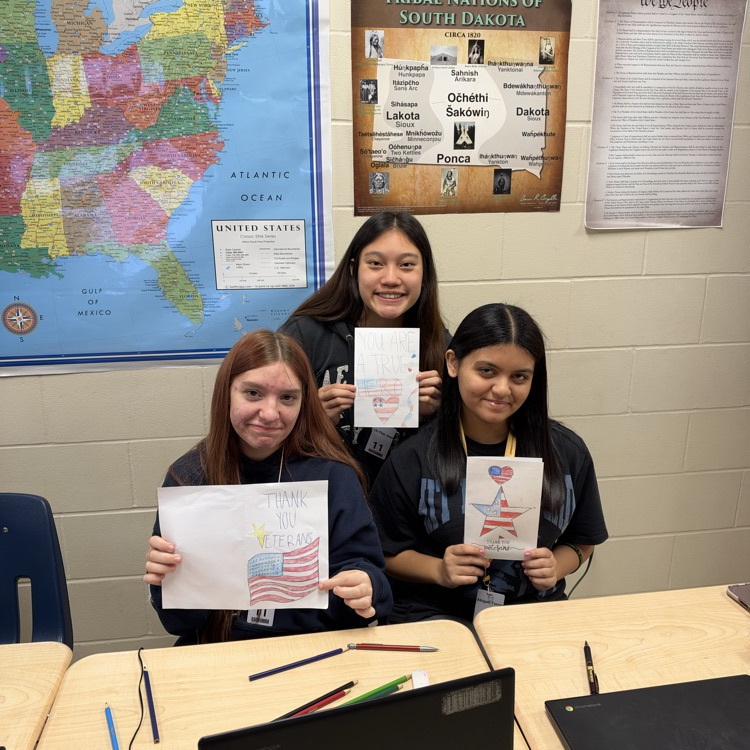 Students working on cards at their desks.