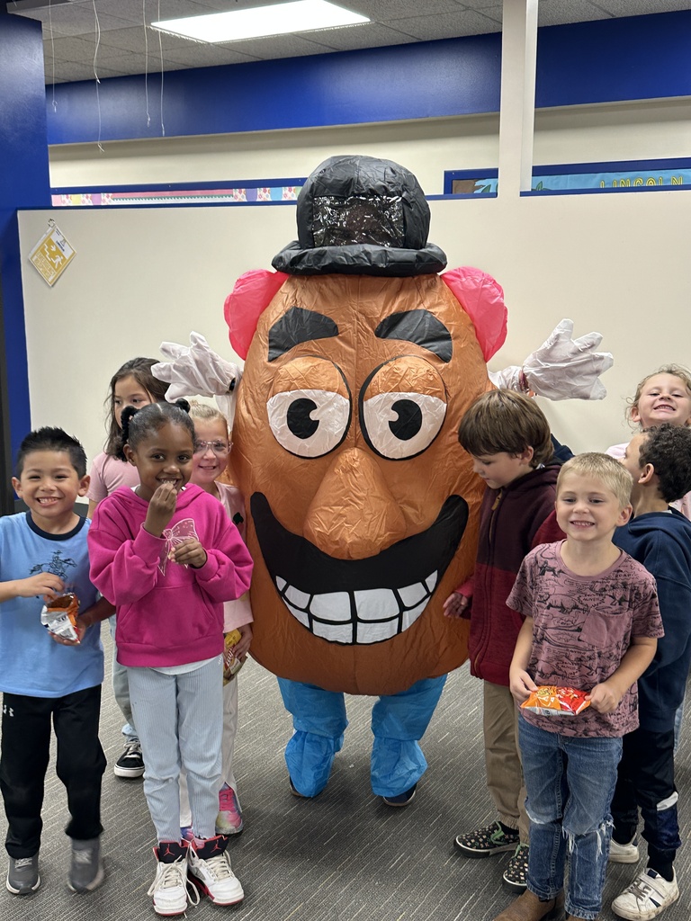 Happy children posing with Mr Potato Head