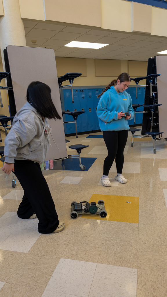 SMS 8th graders racing the cars they made in robotics