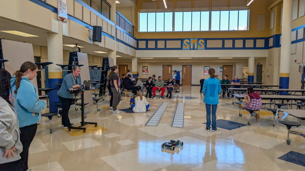 SMS 8th graders racing the cars they made in robotics