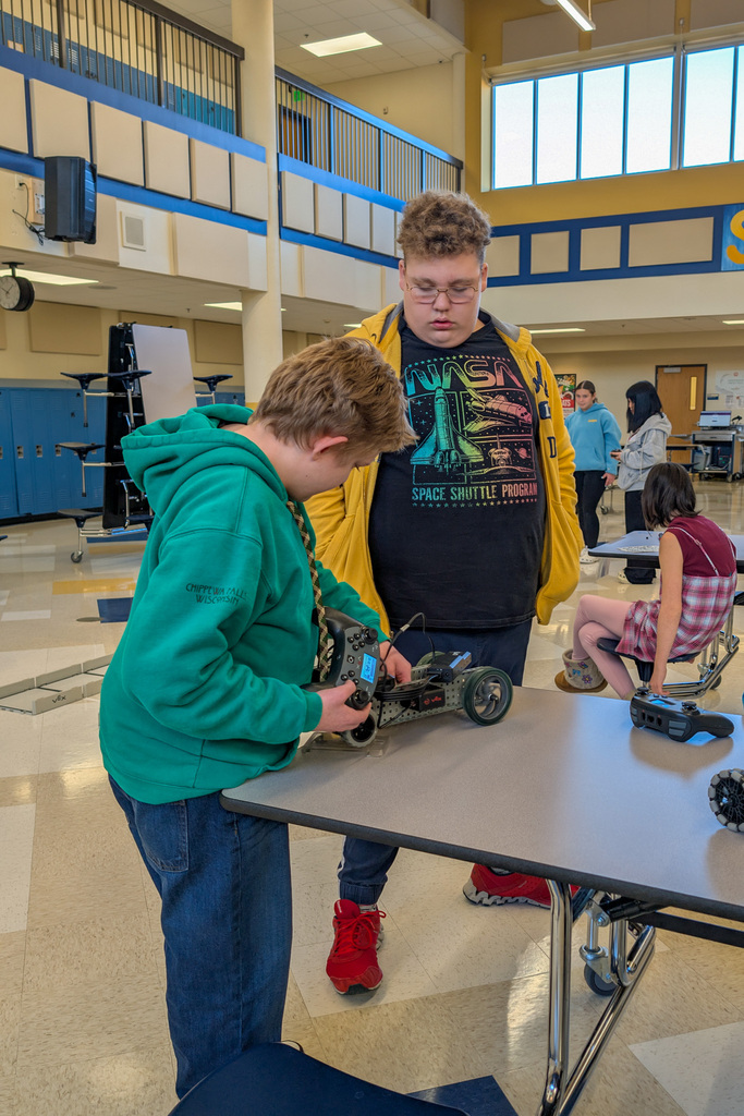 SMS 8th graders working on the cars they made in robotics