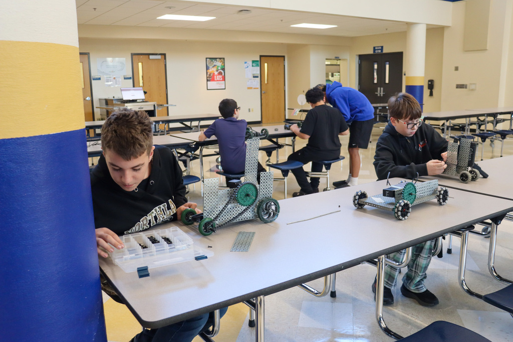 SMS 8th graders working on the cars they made in robotics