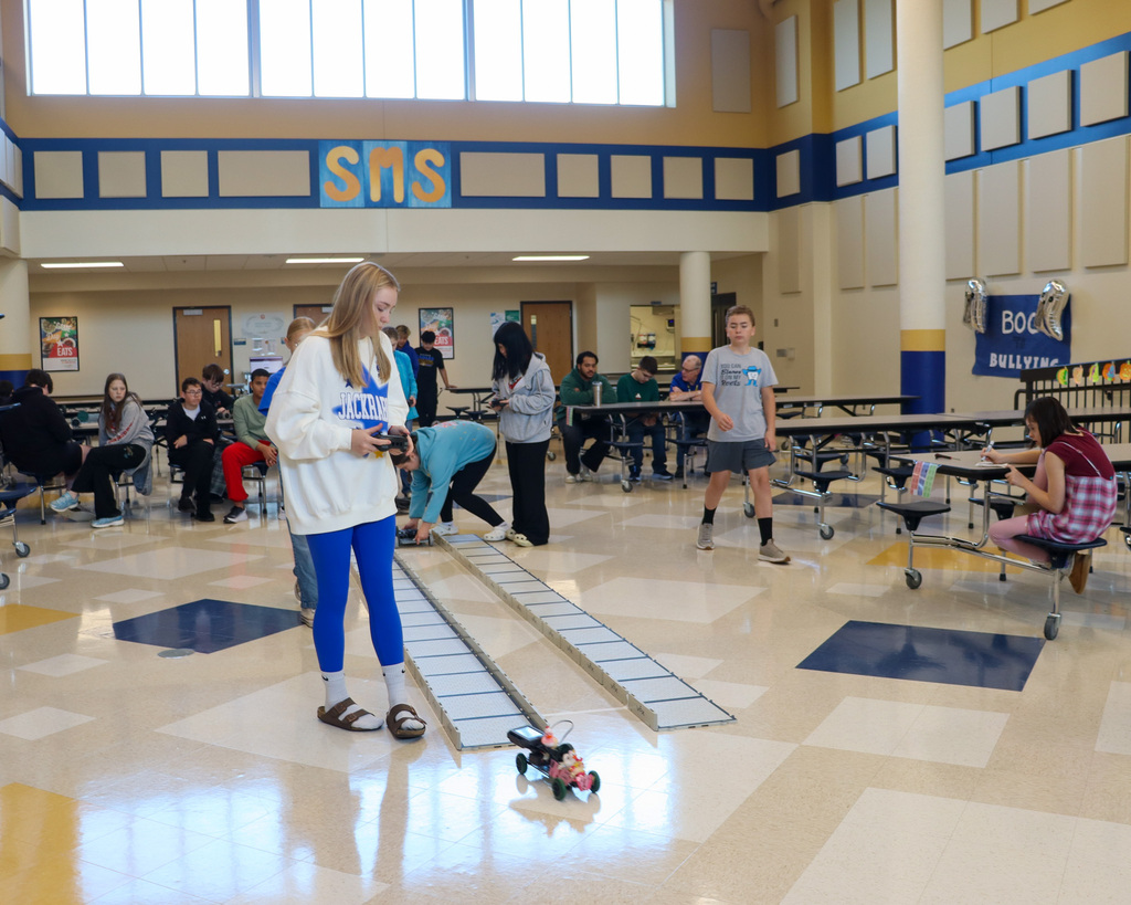 SMS 8th graders racing the cars they made in robotics