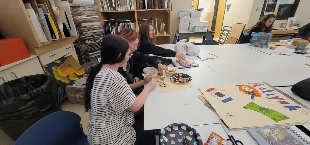 Art club members are collaborating on making Spooky Cookies!